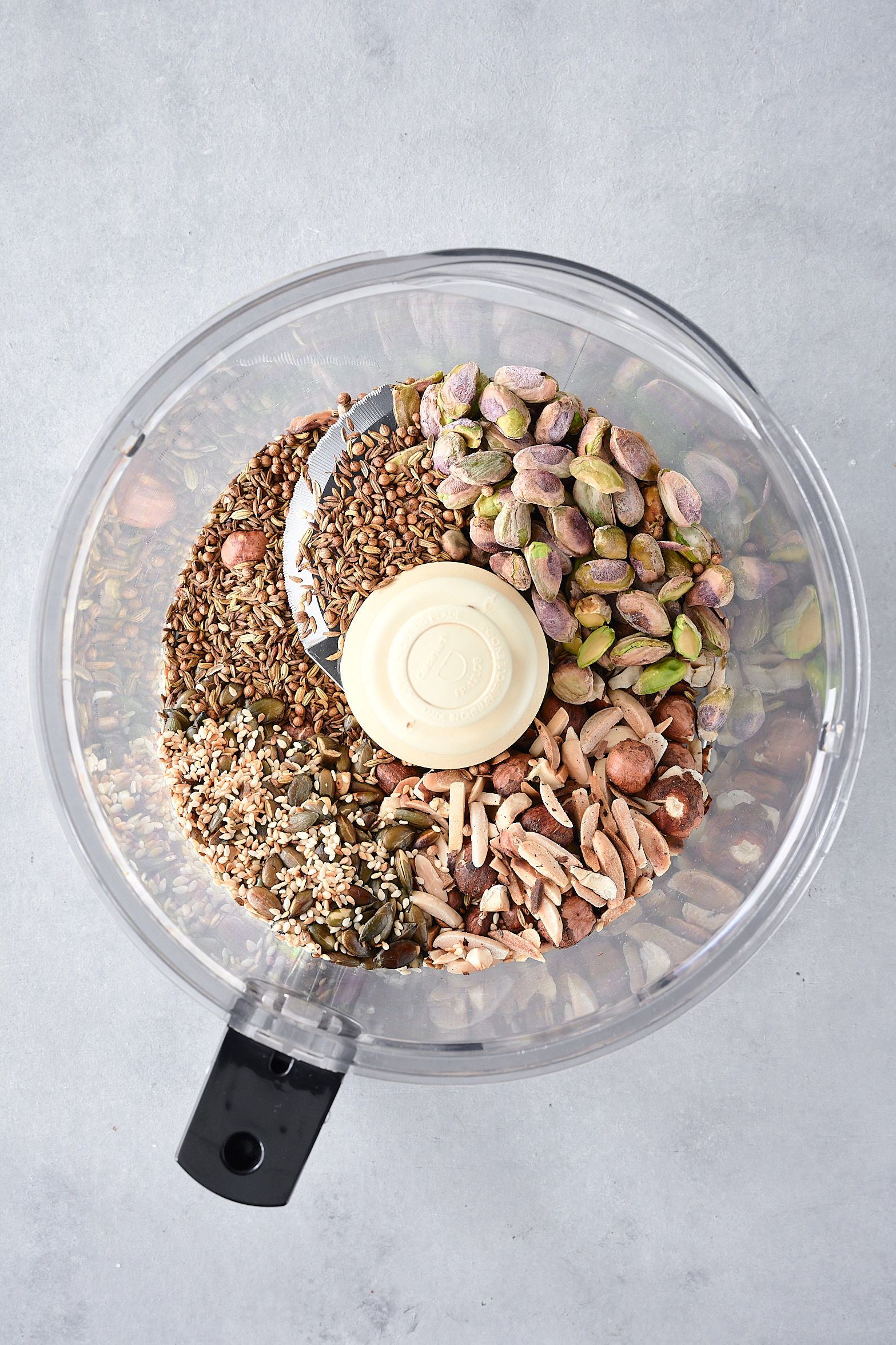 Dukkah ingredients in a food processor