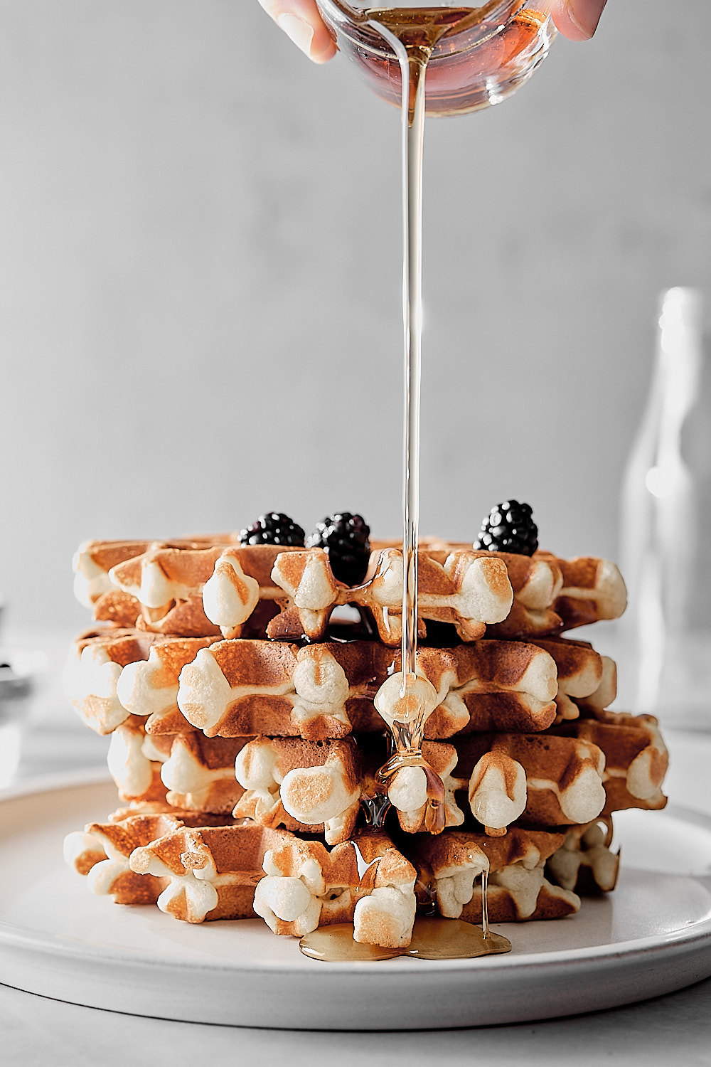 vegan belgian waffles with maple syrup dripped over 